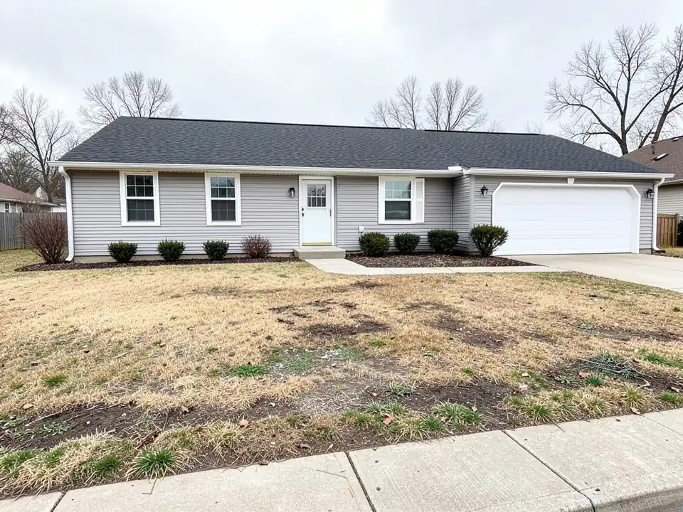 AI-generated example: gray single-story ranch house with a white garage door and a patchy front lawn of dry brown grass and bare dirt