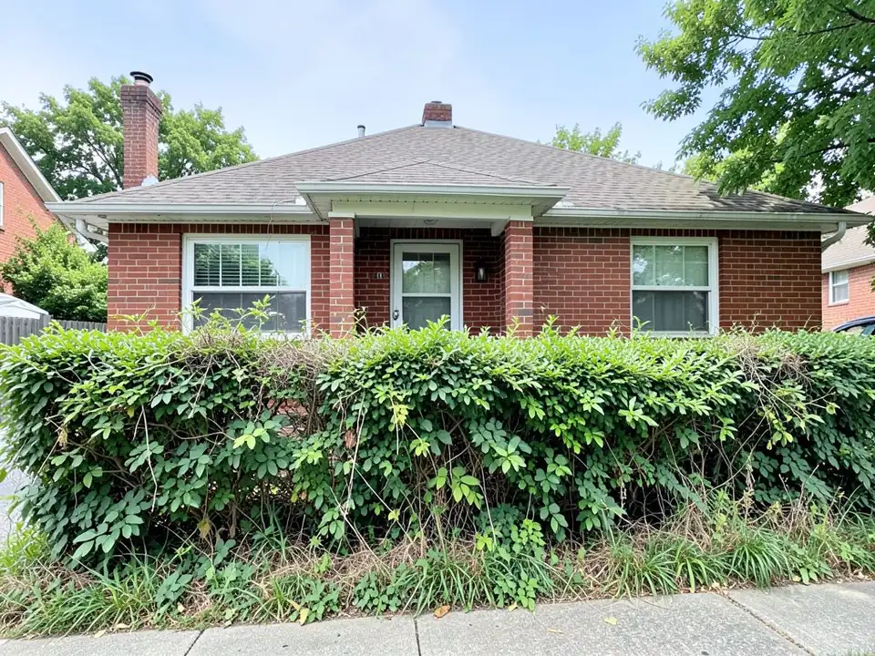 AI-generated example: a one-story red brick house with a hip roof, a recessed white front door between two brick pillars and two white windows, almost hidden behind an overgrown, tangled green hedge that runs across the whole front, with a weedy grass strip and a concrete sidewalk in the foreground