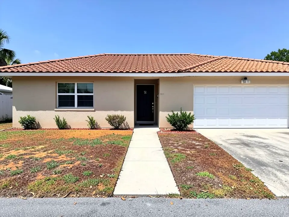 AI-generated example: a beige stucco single-story house with a terracotta tile roof, a black front door, a white two-car garage door on the right, a few small shrubs along the wall, a sunburnt, patchy lawn and a straight concrete walk from the street to the door