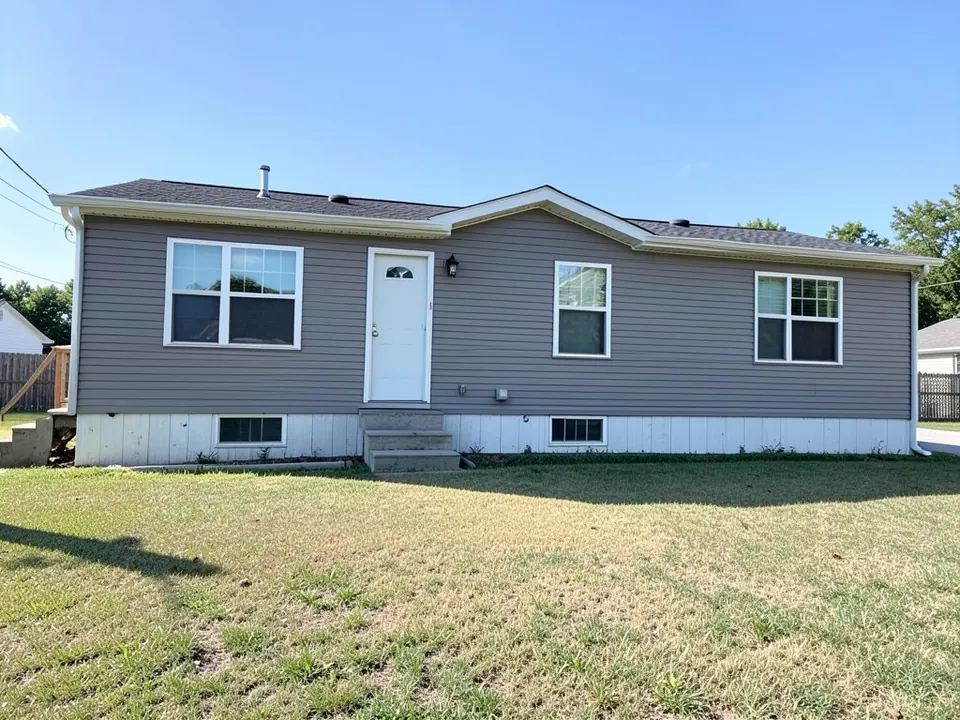 AI-generated example: a double-wide manufactured home with grey lap siding, white trim, four windows, a white front door with concrete steps and white skirting with vents, with a flat, patchy lawn in front and a wooden stair at the left end