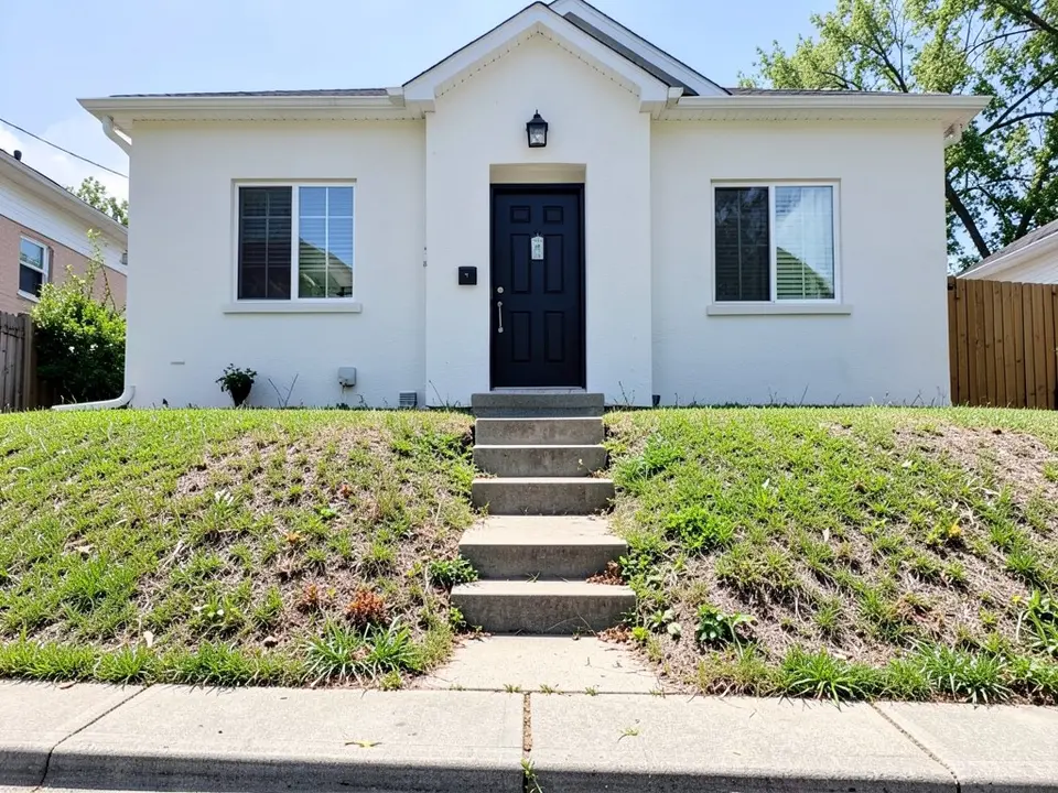 AI-generated example: a plain white stucco house with a black front door and a front yard on a gentle slope, covered in patchy lawn and weeds, with short concrete steps in the middle and a sidewalk at the bottom