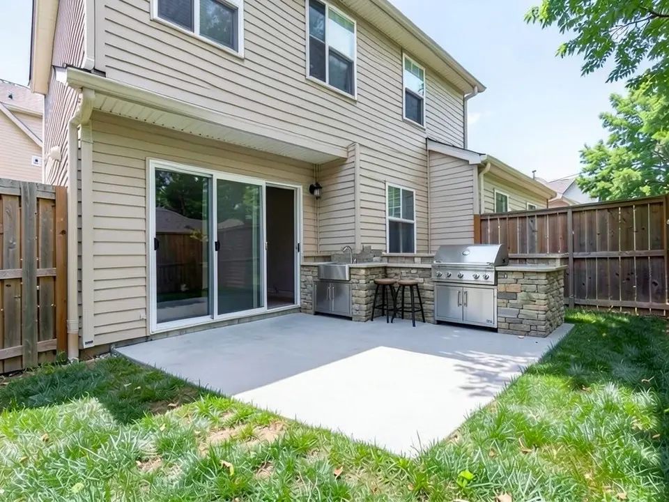 AI-edited version of the same image: a stone-clad counter along the house wall at the right end of the patio with a stainless steel sink at its left end, a stainless built-in grill with cabinet doors under it at its right end, and two bar stools in front of the counter